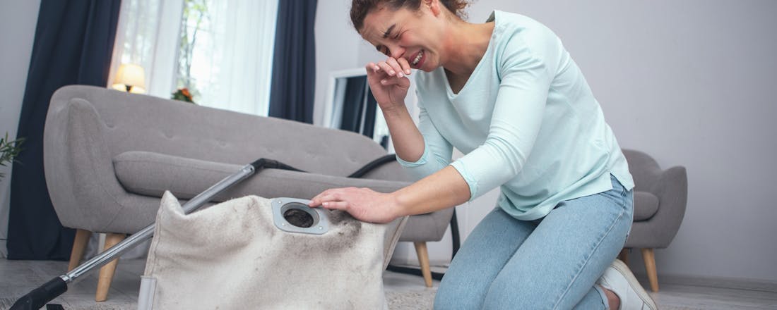 Vrouw niest bij legen stofzak De stofzuiger: je geheime wapen tegen allergieën